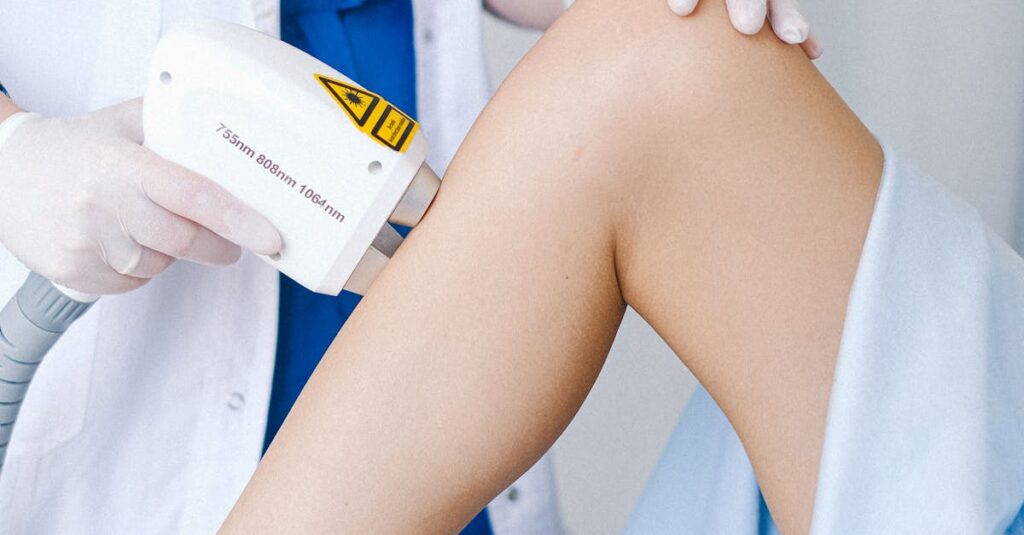 Crop unrecognizable doctor in medical uniform and gloves using professional equipment for low level laser therapy for client